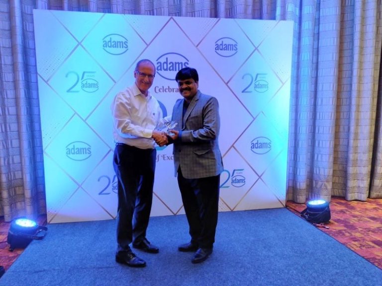 Link Engineering Company EVP Tim Duncan presents Adams Engineering Managing Partner Ganesh Venkata with a crystal trophy commemorating Adams Engineering’s Silver Jubilee