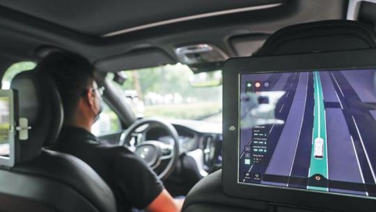 A driver participates in an autonomous driving road test in Shanghai