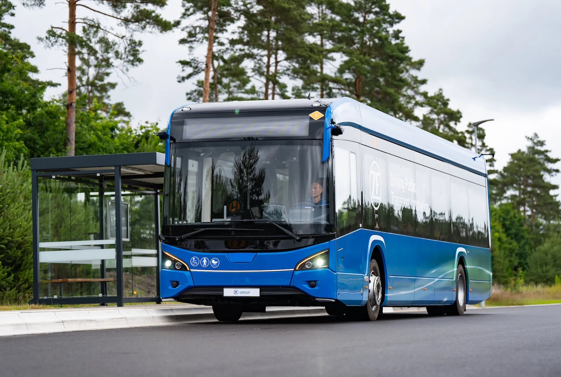 ZF electric city bus demonstrating City Bus CMS collision-mitigation braking at a bus stop on the CV Tech Day test track.