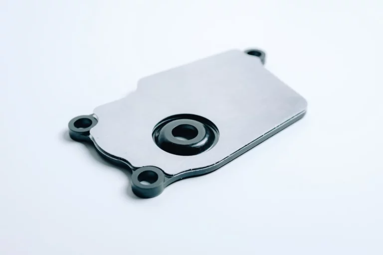 NRS GRIP METAL heat shield for the Chevrolet Corvette C8 exhaust actuator, with aluminum skins over a glass-reinforced phenolic core.