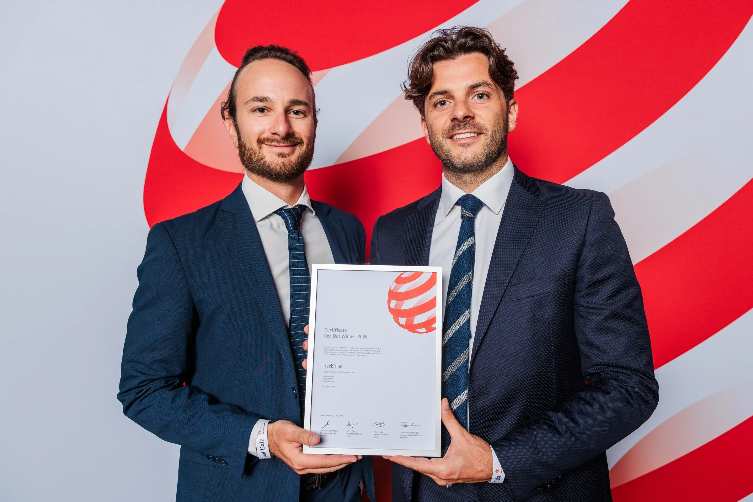 Brembo executives holding the Red Dot Award 2026 certificate for TrackTribe at the Red Dot Gala in Essen, Germany.